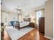 Primary bedroom featuring hardwood floors, a ceiling fan, and natural light at 9032 Cypress Glen Ct, Weeki Wachee, FL 34613