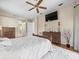 The primary bedroom features a ceiling fan, hardwood floors, and neutral décor at 9032 Cypress Glen Ct, Weeki Wachee, FL 34613