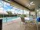 Outdoor living at its finest with a covered patio, stylish seating, and a sparkling pool with screened enclosure at 9032 Cypress Glen Ct, Weeki Wachee, FL 34613