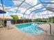 Enjoy a sparkling pool with a screened enclosure, providing a relaxing outdoor retreat at 9032 Cypress Glen Ct, Weeki Wachee, FL 34613