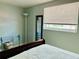 Bright bedroom with natural light, modern floors, and cozy decor, creating a peaceful retreat at 9136 Mark Twain Ln, Port Richey, FL 34668