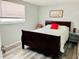 Comfortable bedroom featuring wood-look floors, neutral walls, and a cozy bed at 9136 Mark Twain Ln, Port Richey, FL 34668
