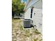 Exterior of home featuring modern AC unit, siding, and windows, highlighting essential systems at 9136 Mark Twain Ln, Port Richey, FL 34668