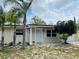 Charming home exterior with manicured front yard and inviting entrance, offering curb appeal at 9136 Mark Twain Ln, Port Richey, FL 34668