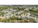 Aerial neighborhood view highlighting a home with a pool surrounded by other residences and mature landscaping at 9301 Tournament Dr, Hudson, FL 34667