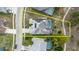 Aerial view of a property with a screened pool, solar panels, and a well-maintained backyard at 9301 Tournament Dr, Hudson, FL 34667