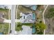 Aerial view of a home with a private pool, solar panels, and a well-maintained roof in a residential neighborhood at 9301 Tournament Dr, Hudson, FL 34667
