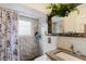 Modern bathroom with marble tiles, stylish fixtures, and a shower at 9301 Tournament Dr, Hudson, FL 34667