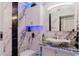 Modern bathroom with marble walls, unique sink, and accent lighting at 9301 Tournament Dr, Hudson, FL 34667