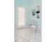Bright bathroom featuring a toilet, an exit door, and storage shelves for added convenience and functionality at 9301 Tournament Dr, Hudson, FL 34667