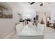 Open dining area with a glass table and views into the kitchen and fireplace at 9301 Tournament Dr, Hudson, FL 34667