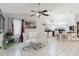 Bright open-concept dining area flowing into the kitchen with white tile floors at 9301 Tournament Dr, Hudson, FL 34667