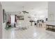 Open-concept view of dining area with white tiled floors and fireplace at 9301 Tournament Dr, Hudson, FL 34667