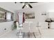 Bright dining area featuring a glass table, white chairs, and modern decor at 9301 Tournament Dr, Hudson, FL 34667