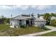 This beautiful home offers a three-car garage, lush landscaping, and elegant architectural details at 9301 Tournament Dr, Hudson, FL 34667