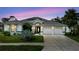Beautiful home featuring a two-car garage, well-manicured lawn, and gorgeous front yard landscaping at 9301 Tournament Dr, Hudson, FL 34667