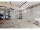 Finished garage with tiled floors, refrigerator, and ample storage, perfect for a workshop or hobby area at 9301 Tournament Dr, Hudson, FL 34667