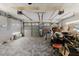 Spacious garage with tiled floors, overhead door openers, and ample storage, perfect for organization at 9301 Tournament Dr, Hudson, FL 34667