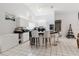 Bright eat-in kitchen features white cabinets, island with bar seating, and tile floors at 9301 Tournament Dr, Hudson, FL 34667