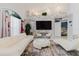 Bright living room features white tile floors, modern furniture, and eye-catching stone wall at 9301 Tournament Dr, Hudson, FL 34667