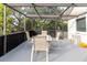 Covered patio featuring a dining table with chairs, offering a serene outdoor dining experience at 9301 Tournament Dr, Hudson, FL 34667