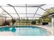 Screened pool with clear water, landscaped views, and covered enclosure offering a relaxed outdoor oasis at 9301 Tournament Dr, Hudson, FL 34667