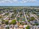 Panoramic aerial shot displays the home within a large residential area with lakes and green spaces at 9316 Whitman Ln, Port Richey, FL 34668