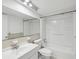 Clean bathroom features a classic white sink, toilet, and bathtub with built-in shelving at 9316 Whitman Ln, Port Richey, FL 34668