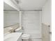 Clean bathroom features a classic white sink, toilet, and bathtub with built-in shelving at 9316 Whitman Ln, Port Richey, FL 34668