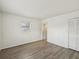 Spacious bedroom with stylish flooring, large window, and convenient closet at 9316 Whitman Ln, Port Richey, FL 34668