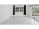Empty room with sliding glass door, tile floors, and a view to the backyard at 9316 Whitman Ln, Port Richey, FL 34668