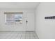 Light and airy entryway featuring tile floors, front door, and ample natural light from window at 9316 Whitman Ln, Port Richey, FL 34668