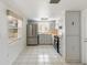 Kitchen with stainless steel appliances, white cabinetry, and bright lighting at 9316 Whitman Ln, Port Richey, FL 34668