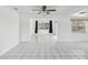 Bright, open living space features tile flooring, neutral walls and a view into another room at 9316 Whitman Ln, Port Richey, FL 34668