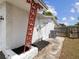 Exterior shot of home features an air conditioning unit, garden area and gate at 9316 Whitman Ln, Port Richey, FL 34668
