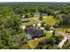 Scenic aerial view showcasing a private home with a pool and expansive green space at 10110 Weeks Dr, Brooksville, FL 34601