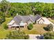 Aerial view of the home showcasing its large lot, mature trees, and three-car garage at 10110 Weeks Dr, Brooksville, FL 34601