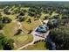 Aerial view of the golf course and community pool area with an abundance of golf carts at 10110 Weeks Dr, Brooksville, FL 34601
