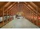 Unfinished attic space with exposed beams and ample storage potential at 10110 Weeks Dr, Brooksville, FL 34601