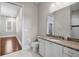 Bathroom vanity with granite countertop, single sink, white cabinetry, and view into adjacent room at 10110 Weeks Dr, Brooksville, FL 34601