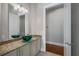 Stylish bathroom featuring an eye-catching vessel sink and granite countertops on custom cabinetry at 10110 Weeks Dr, Brooksville, FL 34601
