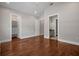 Spacious bedroom with hardwood floors and direct access to a walk-in closet and an ensuite bathroom at 10110 Weeks Dr, Brooksville, FL 34601