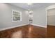 Bedroom with hardwood floors leading to an ensuite bathroom and a walk-in closet at 10110 Weeks Dr, Brooksville, FL 34601