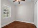 Bright bedroom with hardwood floors, a window with blinds, and a closet for ample storage at 10110 Weeks Dr, Brooksville, FL 34601