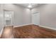 Bedroom with hardwood floors and entryways to both an ensuite bath and large walk-in closet at 10110 Weeks Dr, Brooksville, FL 34601
