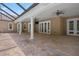 Spacious covered patio features brick pavers, ceiling fans, and access to the pool and backyard at 10110 Weeks Dr, Brooksville, FL 34601