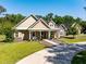 Inviting single-Gathering home with a charming front porch, well-manicured lawn, and tasteful landscaping at 10110 Weeks Dr, Brooksville, FL 34601