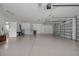Spacious three-car garage with epoxy flooring, storage, and access to main house at 10110 Weeks Dr, Brooksville, FL 34601