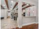 Open-concept kitchen boasting travertine floors and wooden beams at 10110 Weeks Dr, Brooksville, FL 34601