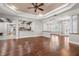 Spacious living room with hardwood floors, tray ceiling, and archways to other rooms in the home at 10110 Weeks Dr, Brooksville, FL 34601